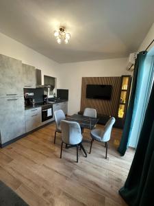 a living room with a table and chairs and a kitchen at 119 Bliss Apartment in Sliema +14 photos