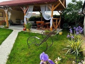 a garden with a bench in the grass at Casa Enka in Tuzla