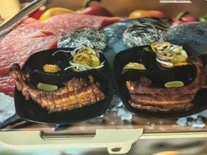 two peppers filled with meat and vegetables on a tray at Hotel Riviera del Atrato in Bojayá