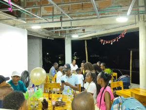 a group of people sitting at tables at a party at Hotel Riviera del Atrato in Bojayá