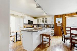 a kitchen with white cabinets and a table and chairs at Mountain Magic in Ketchum +20 photos