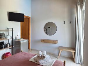 a bedroom with a bed with towels on it at George Studios in Vasiliki