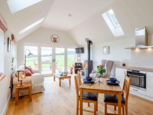 a kitchen and living room with a table and chairs at 1 Bed in Alness oc-83888 in Alness