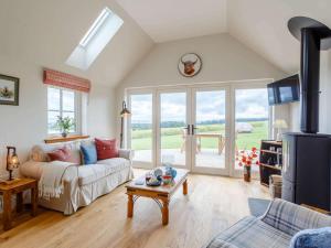 a living room with a couch and a table at 1 Bed in Alness oc-83888 in Alness