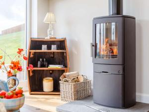 a kitchen with a stove with a fire in it at 1 Bed in Alness oc-83888 in Alness +11 photos