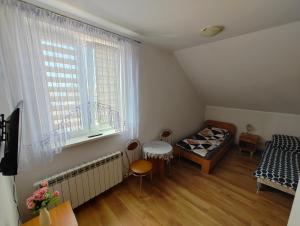 a small room with a bed and a window at Agroturystyka Biedrzycki in Nowe Guty +6 photos