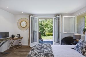 a bedroom with a bed and a sliding glass door at A Casa Bianca in Saint Paul de Vence