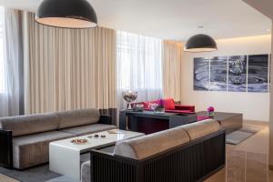 
a living room with a couch and a coffee table at The Boulevard Arjaan by Rotana in Amman
