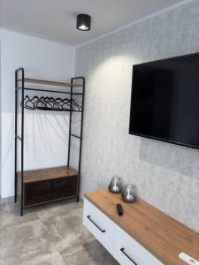 a living room with a flat screen tv on a wall at Piękna Góra House in Gołdap