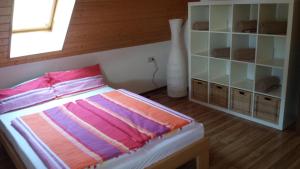 a bedroom with a bed and a book shelf at Ferienwohnung Ringwald in Biederbach Baden-Württemberg