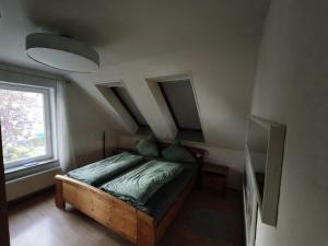 a bedroom with a bed in a room with a window at Harbour Apartment in Moos
