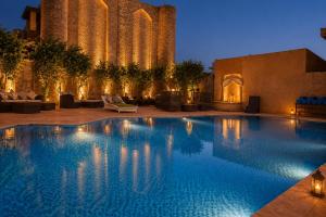 a large swimming pool with a building in the background at WelcomHeritage Ranjitvilas in Amritsar