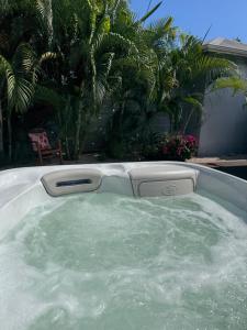 a bath tub filled with water in a yard at Les Galets Sxm Luxury Lodges in Orient Bay
