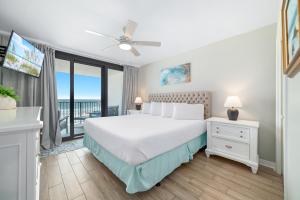 a bedroom with a bed and a balcony at Lei Lani Unit 201T in Orange Beach
