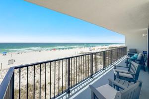 a balcony with chairs and a view of the beach at Lei Lani Unit 201T in Orange Beach