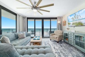 a living room with a couch and a tv at Lei Lani Unit 201T in Orange Beach