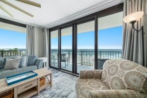 a living room with a couch and a chair at Lei Lani Unit 201T in Orange Beach +49 photos