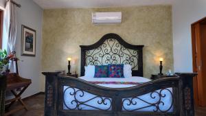a bed in a room with two lamps on tables at Hacienda del Lago Boutique Hotel in Ajijic +111 photos