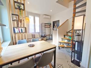 a dining room with a wooden table and chairs at La coulée verte - superbe duplex climatisé - jardin - classé 3 étoiles in Luchon +24 photos