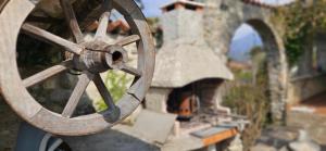 a close up of a wooden wheel on a building at The Hidden Gem, Lago Maggiore in Germignaga