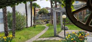 a garden with a pathway and flowers in the grass at The Hidden Gem, Lago Maggiore in Germignaga