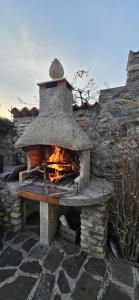 a stone oven with a fire inside of it at The Hidden Gem, Lago Maggiore in Germignaga