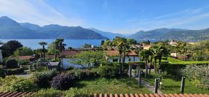 a town with a view of the water and mountains at The Hidden Gem, Lago Maggiore in Germignaga