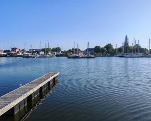 a dock in the middle of a body of water with boats at bateau nuit insolite in Carentan +1 photo