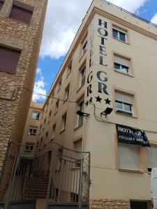 a hotel sign on the side of a building at Hotel GR in Tobarra