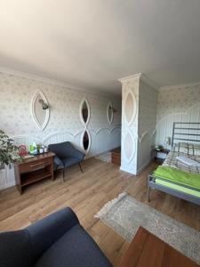 a living room with a couch and a bed at Hotel WIR in Rzgów