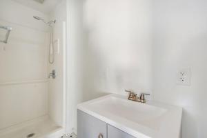 a white bathroom with a sink and a shower at Welcome To Riverside - Spacious, Cozy, Central in Riverside +28 photos