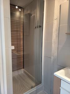 a shower with a glass door in a bathroom at Appartement du Fournil in Bréal-sous-Montfort +8 photos