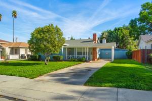 a house with a yard with a driveway at Welcome To Riverside - Spacious, Cozy, Central in Riverside