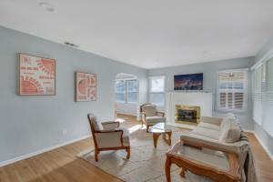 a living room with a couch and chairs and a fireplace at Welcome To Riverside - Spacious, Cozy, Central in Riverside
