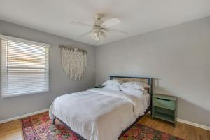 a bedroom with a bed and a ceiling fan at Welcome To Riverside - Spacious, Cozy, Central in Riverside