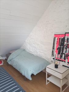 a bedroom with a bed and a table with a mirror at Appartement du Fournil in Bréal-sous-Montfort