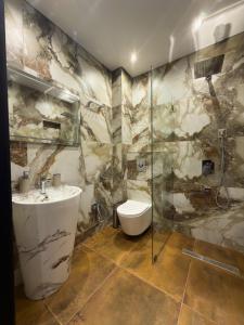 a bathroom with a sink and a shower at Bellissimo Aparthotel Aqua in Shekhvetili