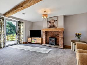 a living room with a fireplace and a television at 2 Bed in Stoke-on-trent oc-95164 in Longton