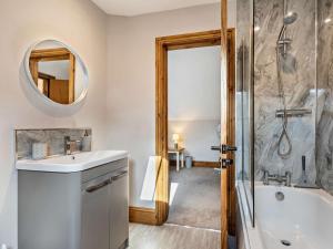 a bathroom with a sink and a tub and a mirror at 2 Bed in Stoke-on-trent oc-95164 in Longton +21 photos