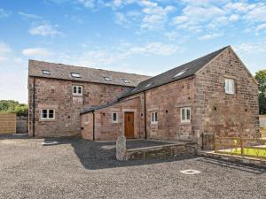 an old brick building with a door in a parking lot at 2 Bed in Stoke-on-trent oc-95164 in Longton