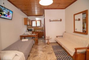 a room with two beds and a desk in it at XeniCamp & Bungalows in Tolo
