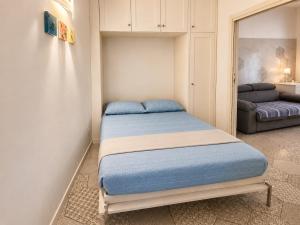 a small bedroom with a bed in a room at Domus Valeria - Suite Boutique Centro Storico Murales Odissea in Sperlonga