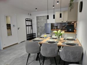 a dining room with a table and chairs at Blue Wave Pobierowo in Pobierowo