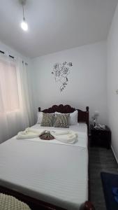 a bedroom with a bed with white sheets and pillows at TINTIN HOMES Mtwapa in Mtwapa