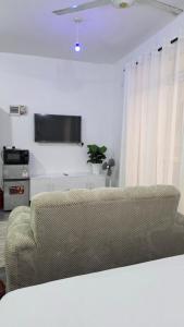 a living room with a couch and a flat screen tv at TINTIN HOMES Mtwapa in Mtwapa