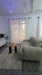 a living room with a couch and a coffee table at TINTIN HOMES Mtwapa in Mtwapa