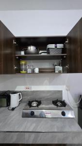 a kitchen with a stove top in a kitchen at TINTIN HOMES Mtwapa in Mtwapa