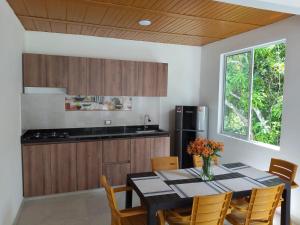 a kitchen and dining room with a table and chairs at La Terraza in Villeta