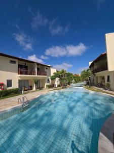 a large swimming pool in front of a building at Solar Águas Pipa Stays in Pipa