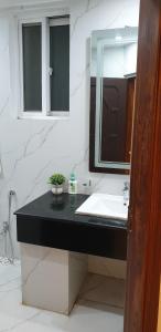 a bathroom with a sink and a mirror at Emerald Villa Islamabad in Islamabad +27 photos